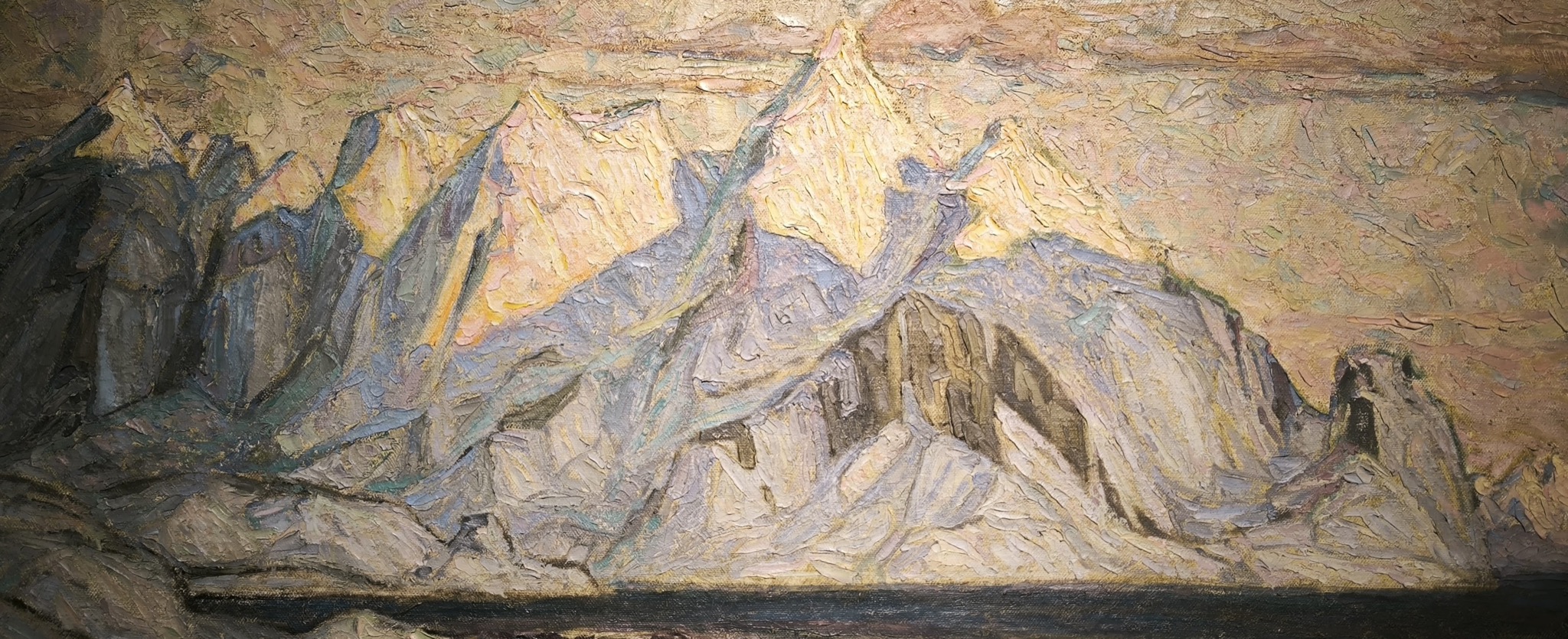 A snow-covered coastal landscape in Lofoten beneath a pale sky